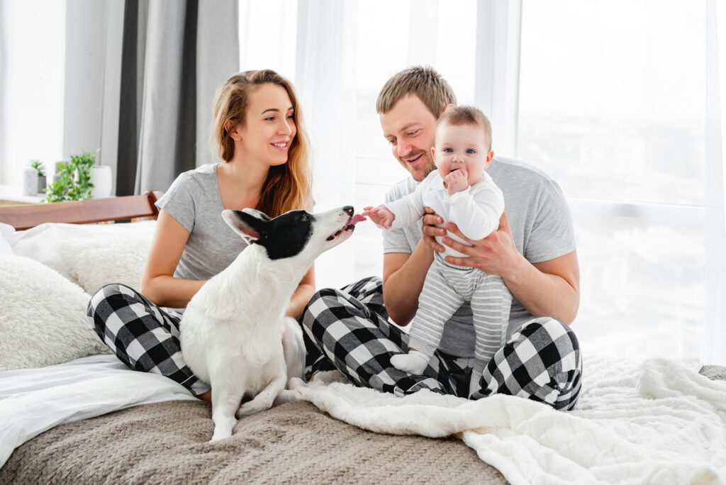 family with dog in the bed